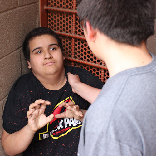 Young man cowering in a corner